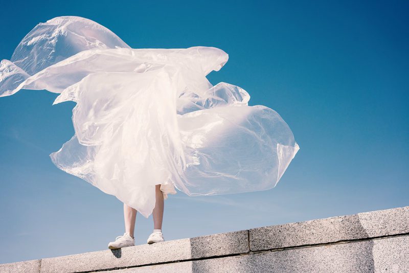 Human wrapped in plastic on top of building