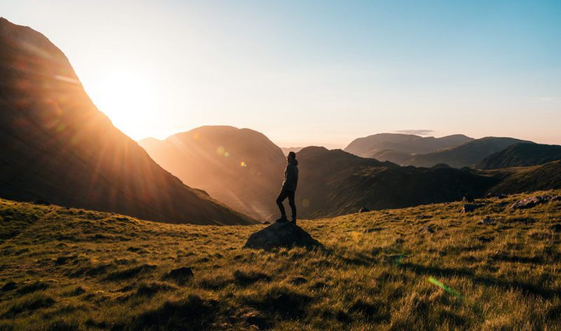 Man standing in hilly landscape