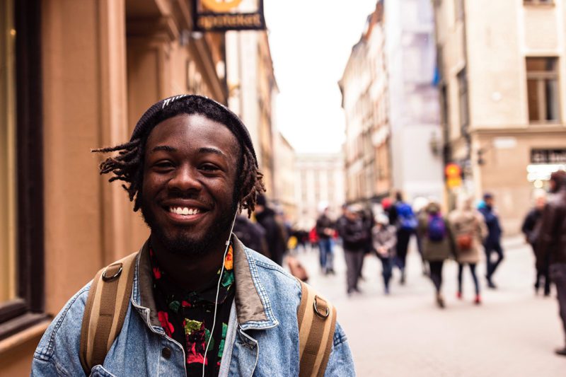 Black Man smiling on street