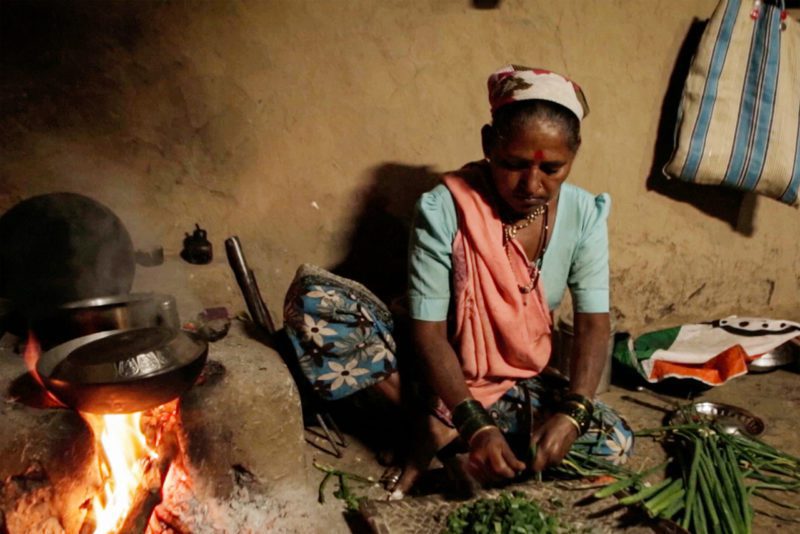 Woman cooking with cookstove