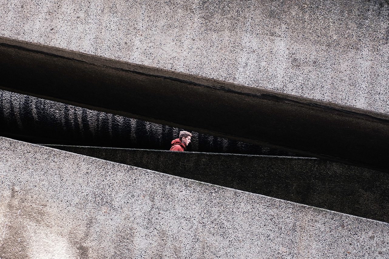 Person passing through architectural feature
