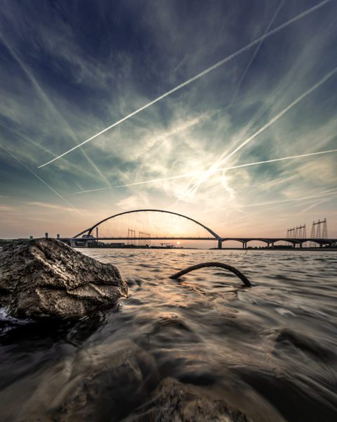 Contrails over bridge