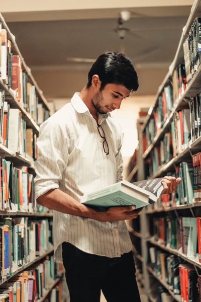 Student reading in university library