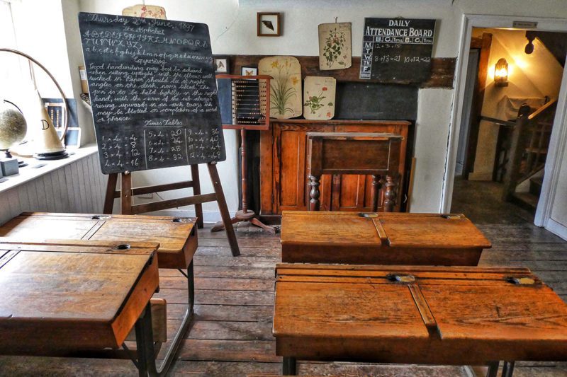 Classroom with wooden desks and blackboard