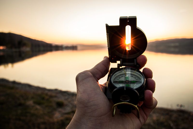Hand holding compass