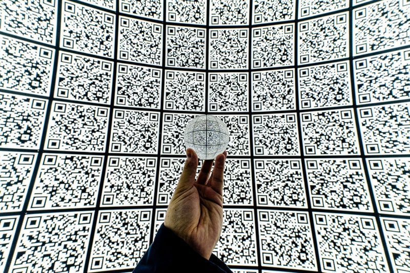 Hand holding circle in middle of squares