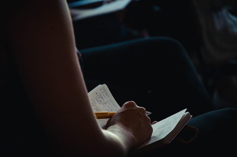 Person with notebook and pen