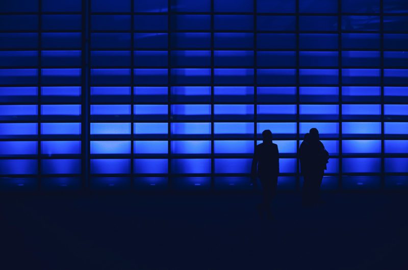 Figures behind blue screened background