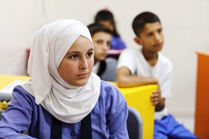 Islamic girl with other students in classroom