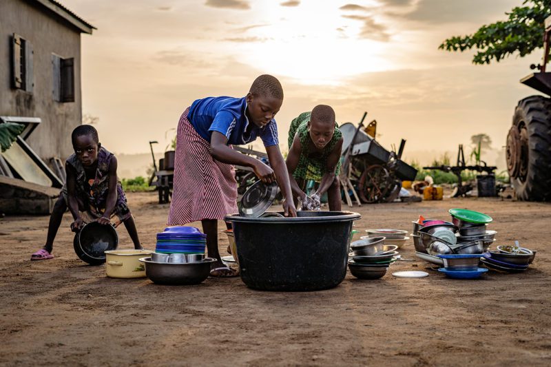 Women washing dishes outside