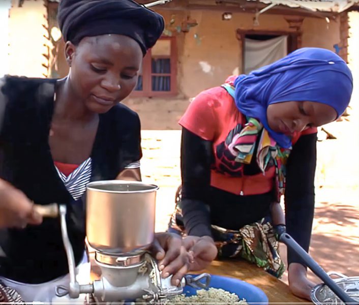Malawii women grinding soaked Soyabeans