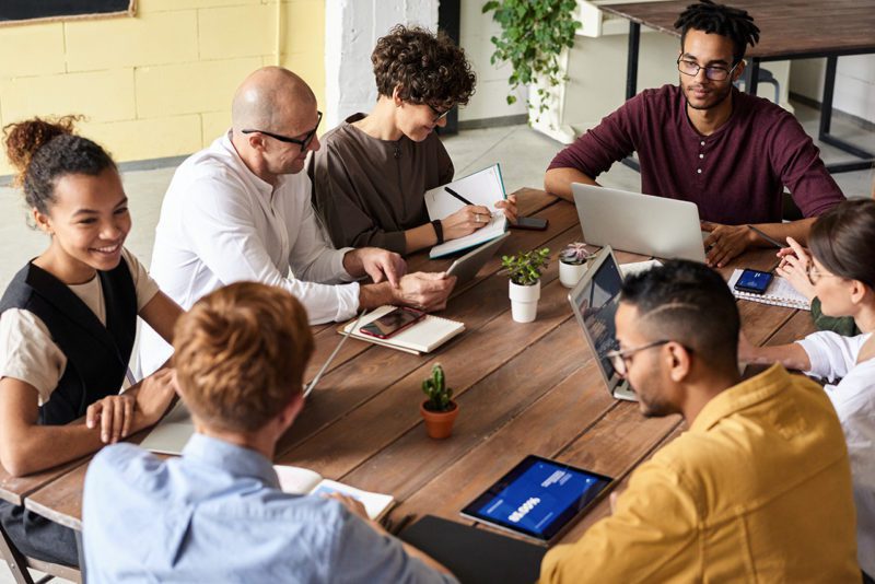 Diverse employees at conference table