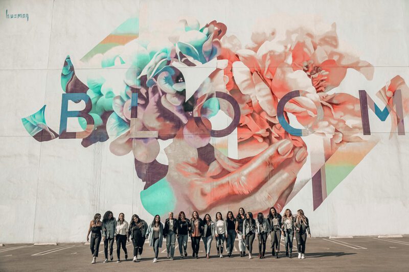 Group of women in front of mural