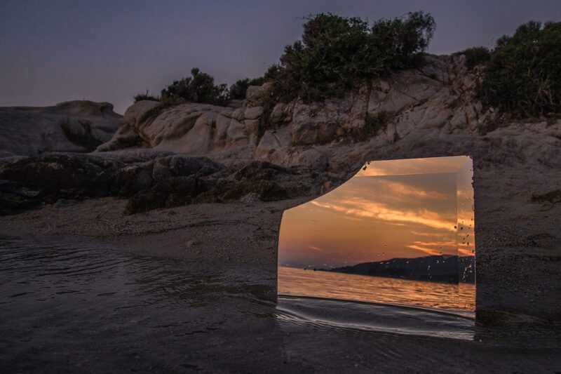 Broken mirror on seashore