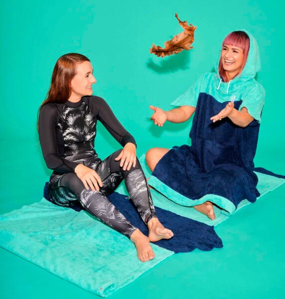 Two women from Vyld seated on green mat