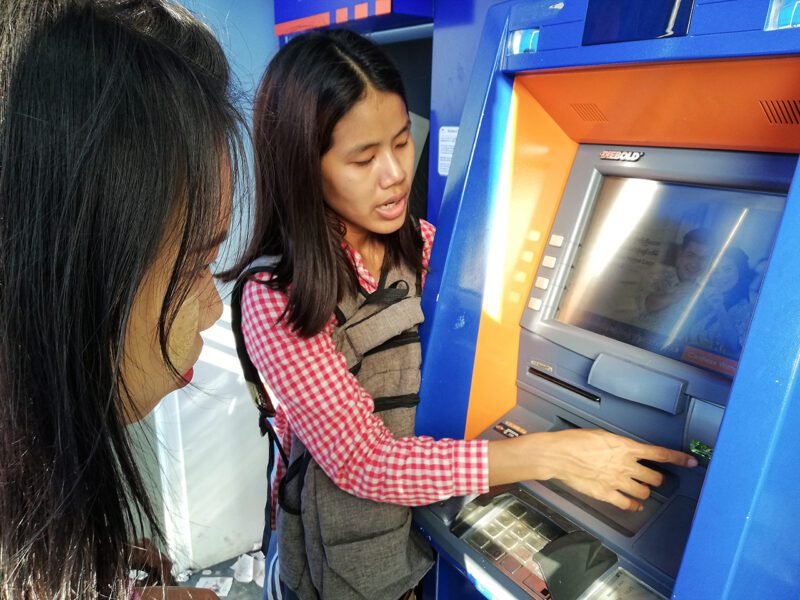 Two women at cash machine