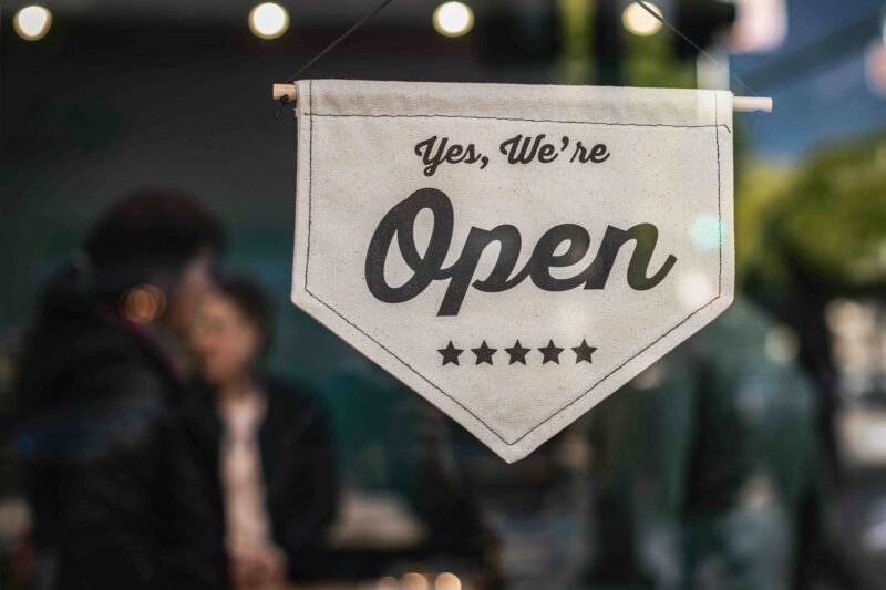 Yes We're Open sign on storefront