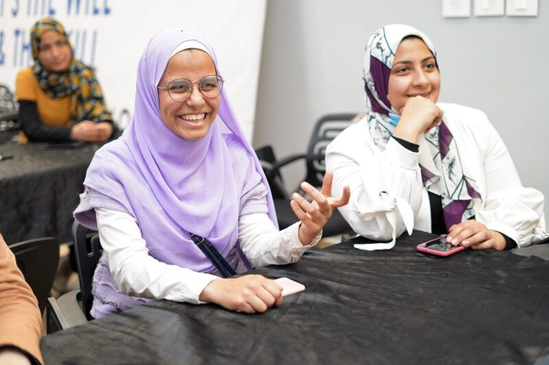 Two Middle Eastern professional women smiling