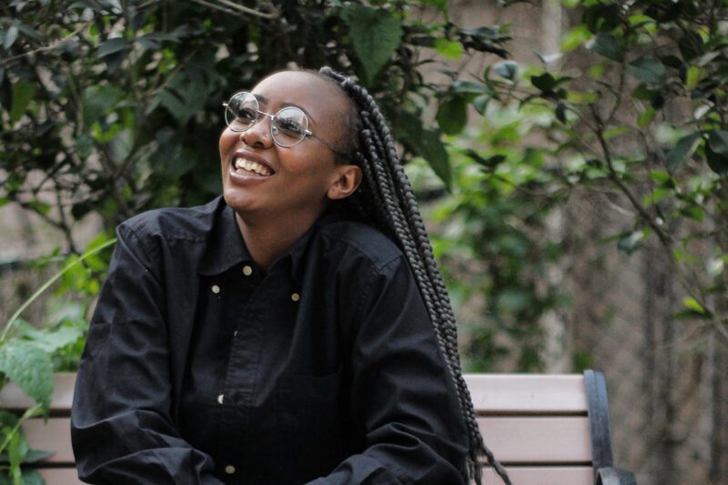 Black woman smiling in park
