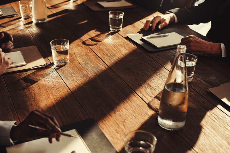 Shadows cross an office conference table 