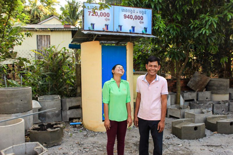 Asians in front of small building