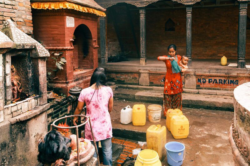 South Asian women with water containers