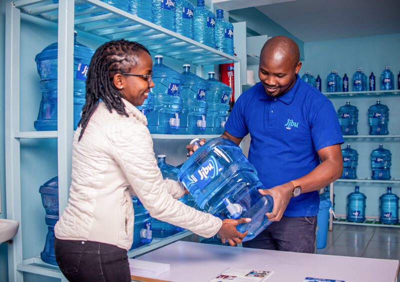 African man and woman at Jibu water distribution center