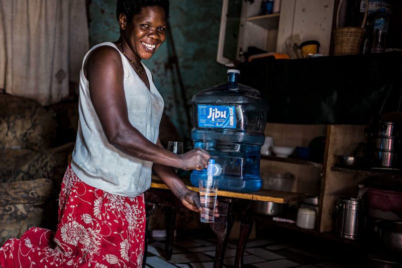 African woman with Jibu water container