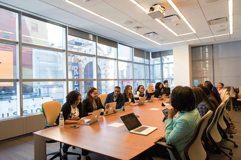 Employees around a conference table meeting