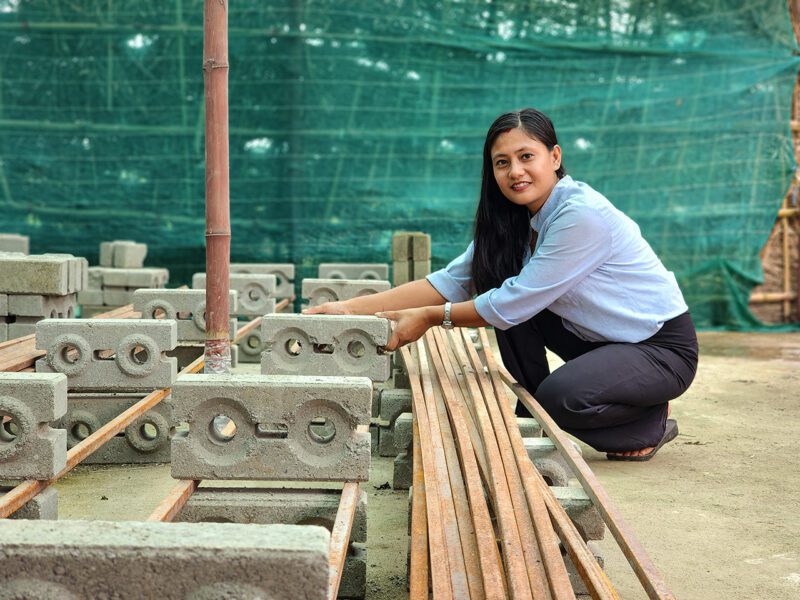 Nepalese female entrepreneur with eco-bricks