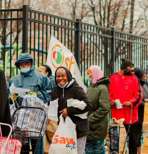 People smiling and standing in line