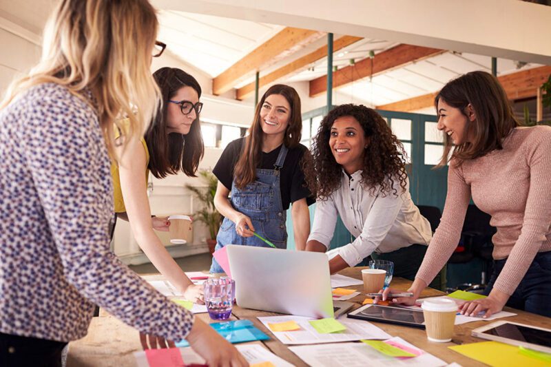 Women professionals standing at a table
