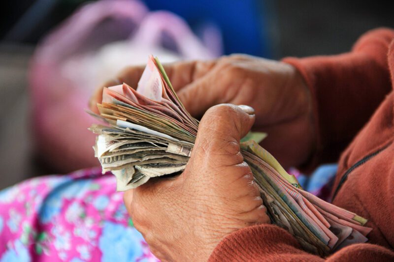 Hands counting wad of cash