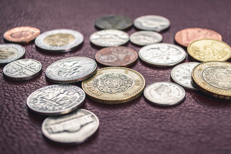 Coins from different currencies on table