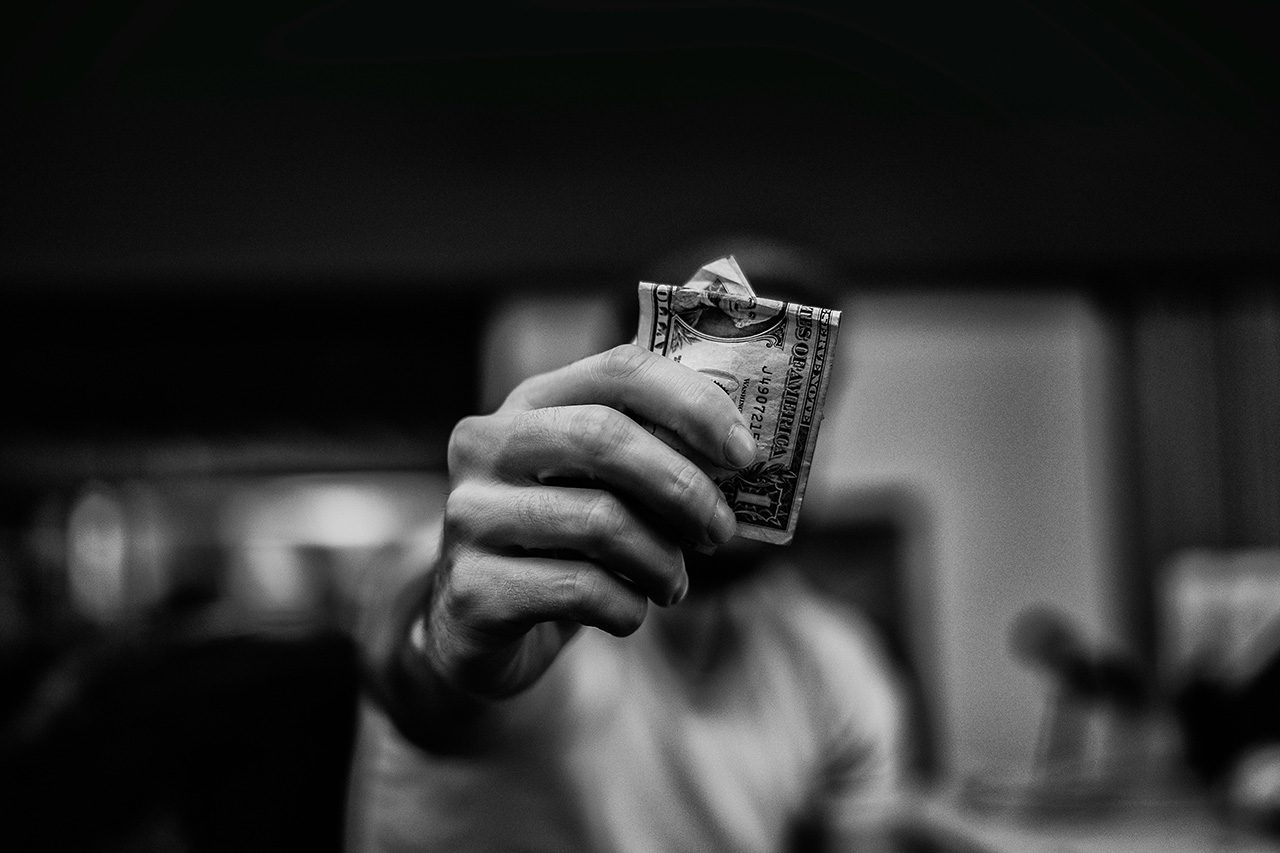 Hand holding wad of cash