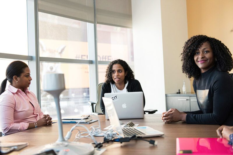 Three women entrepreneurs at conference table