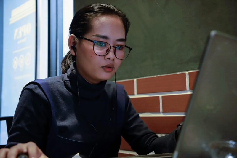 Asian female entrepreneur at computer