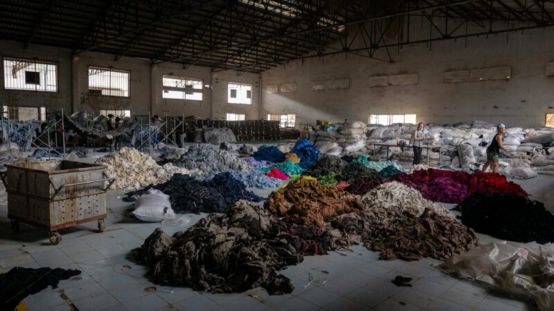 Colorful piles of clothing fabric in warehouse