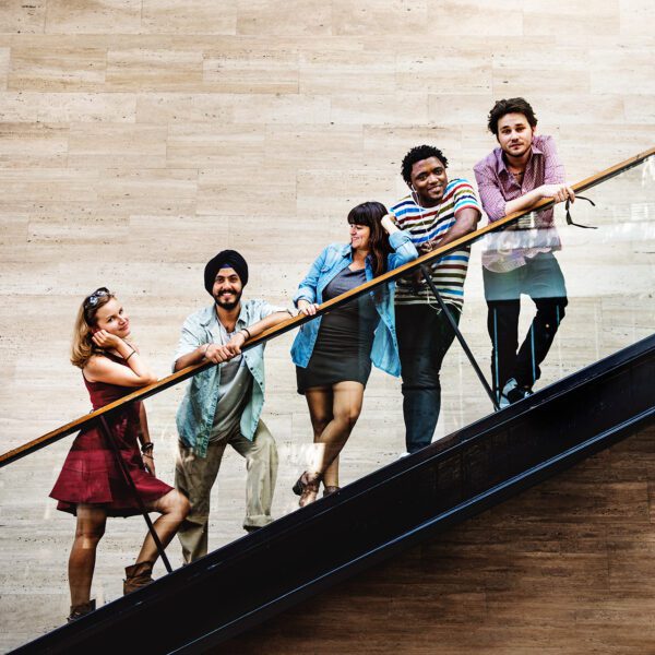 Five diverse professionals on staircase