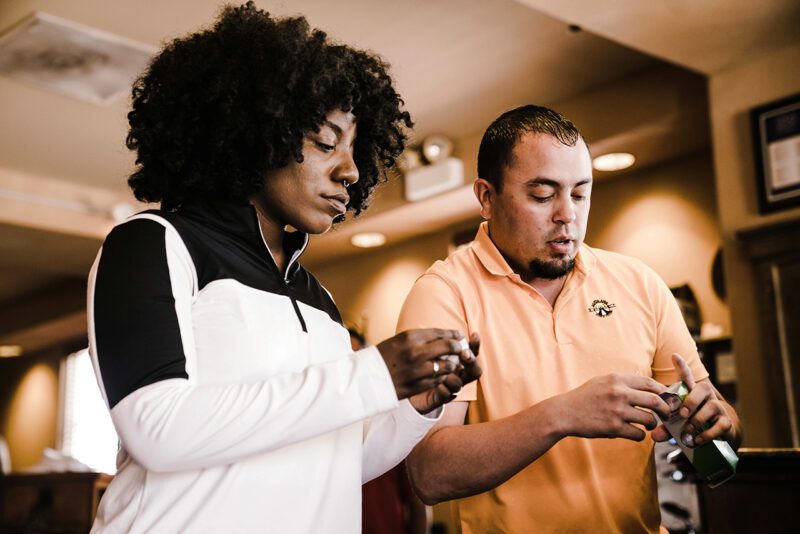 Black woman and latino man working together