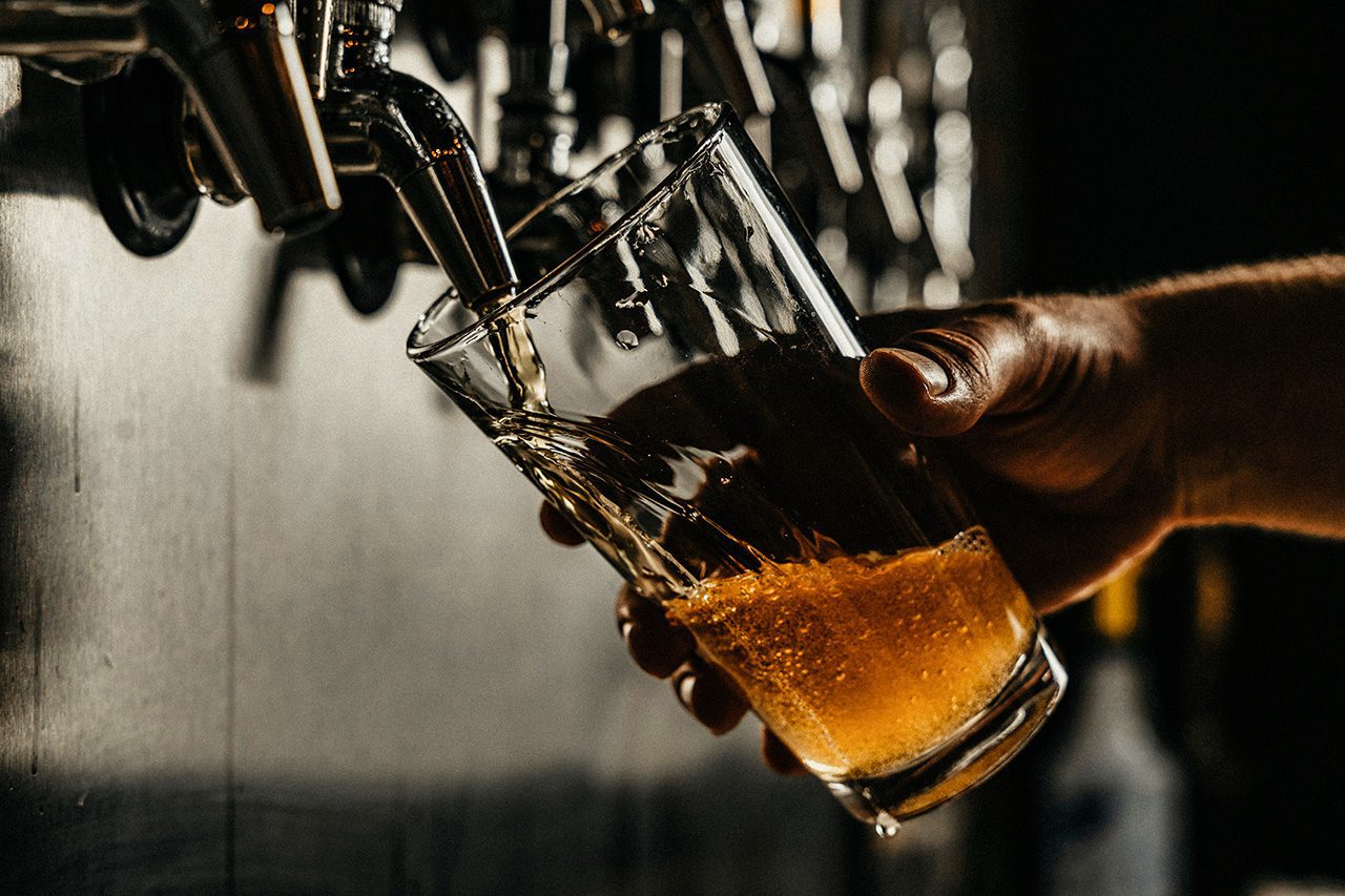 Beer being poured from tap into pint glass