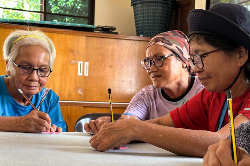 Three Asian women working at table