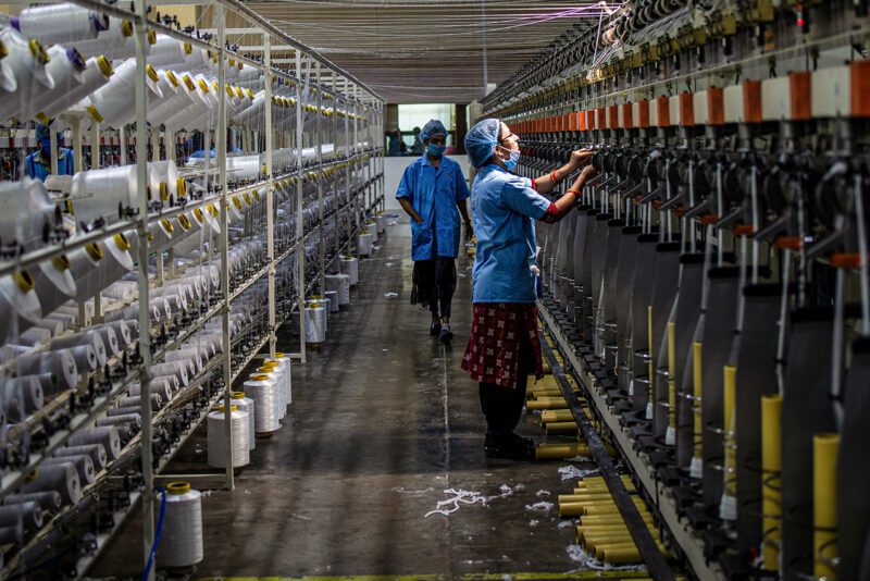 Two workers in an Indian apparel factory