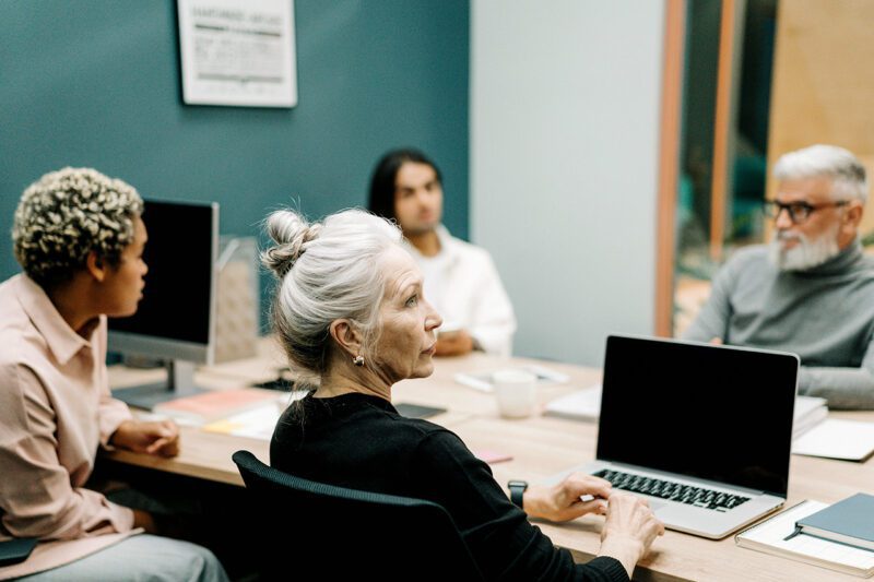 Four employees at conference table