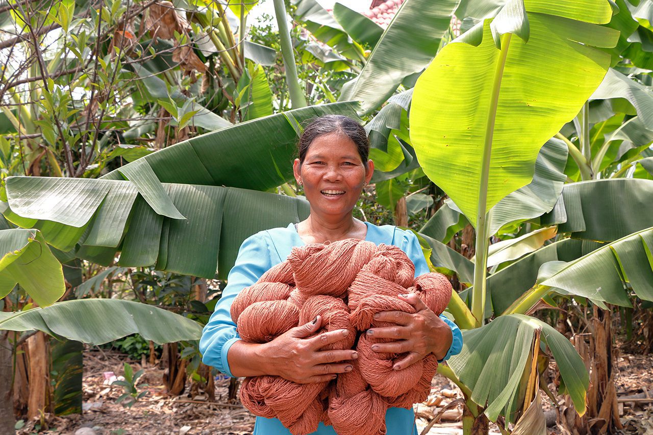 Cambodian woman artisan with wool bundle