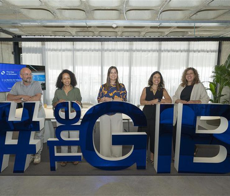 Group of people standing behind big letters