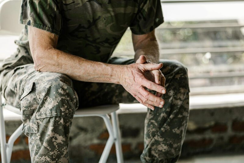 Seated soldier with hands folded