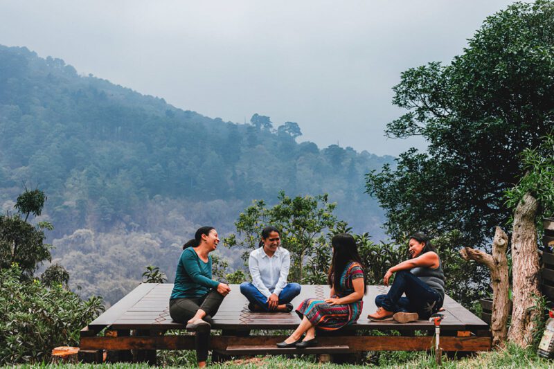 Student entrepreneurs sitting on platform in nature