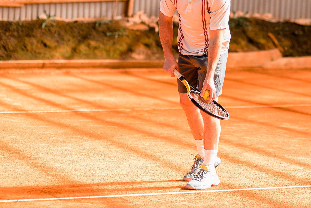 Tennis player on hot court