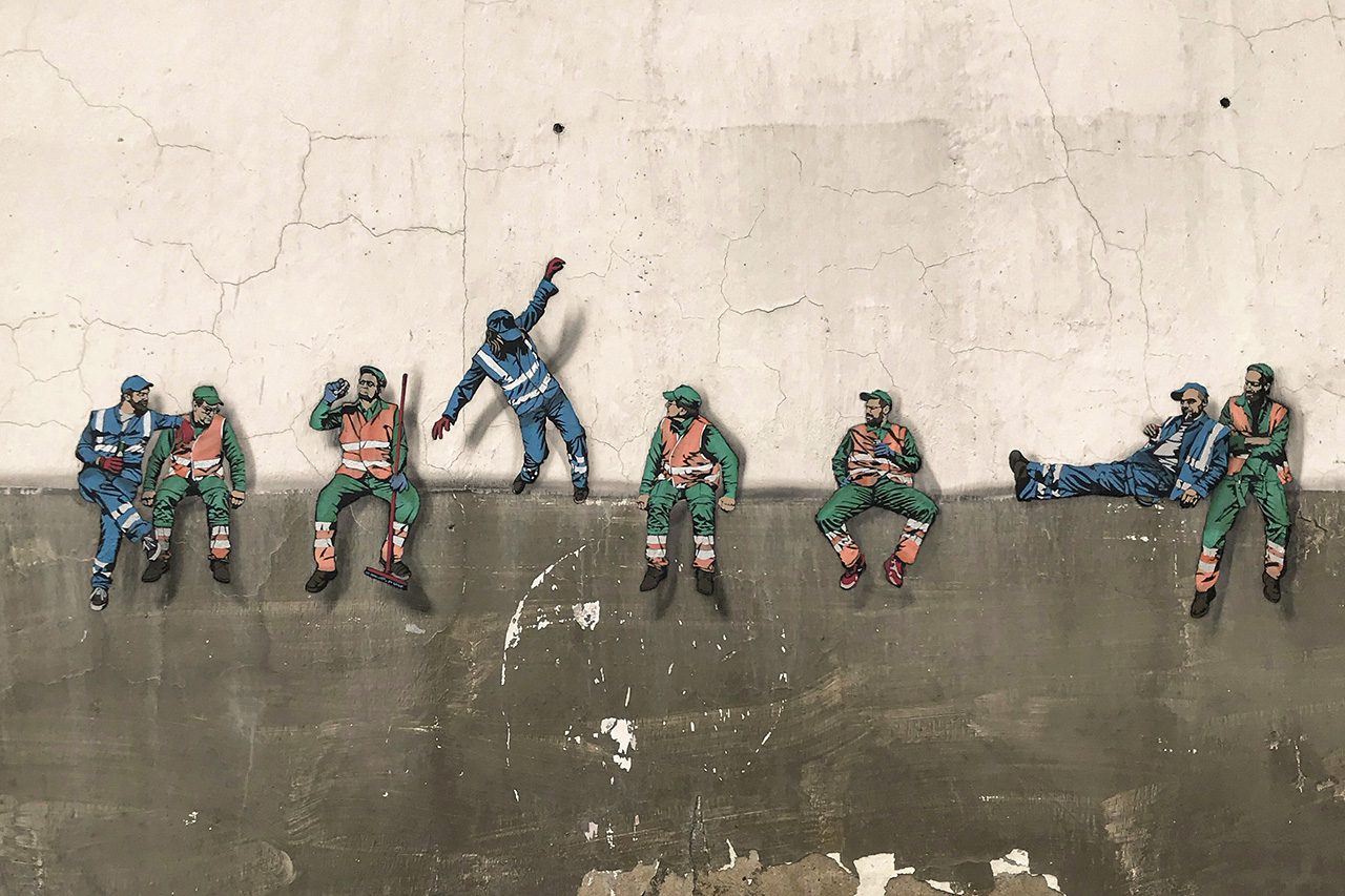 Workers sitting on a wall resting